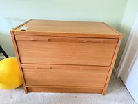 Front view of wood two-drawer lateral file cabinet