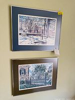 Both framed prints on wall