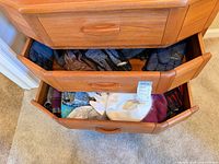 Two drawers showing multiple gloves and scarves