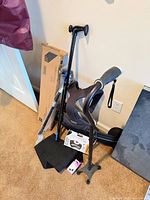 Group of canes, boxed walker, braces against wall