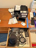 Overview of devices, cases and batteries on dresser and in drawer