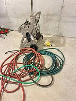 Overview of hose reel cart, coiled hoses, yellow sprinkler