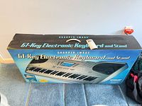 Retail box front showing Sharper Image 61-Key Electronic Keyboard and Stand