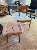 Chair and footstool full view on carpeted floor