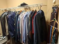 Rack holding sport coats, shirts, and ties