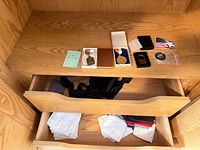 Overview of medals, accessories on shelf and handkerchiefs and bow tie in drawer