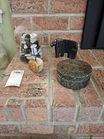 All three decorative items on brick hearth