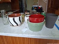 Group shot of all ceramic planters and glass containers on countertop