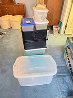 Full stack of six plastic storage containers showing variety and condition