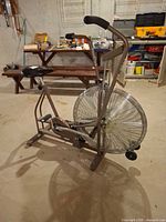 Full side view of bike showing frame, fan wheel, seat and pedals