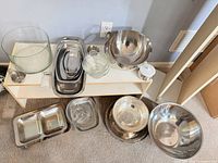 Group shot of all serveware on shelf and floor