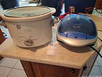 Slow cooker and grill side by side on countertop