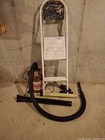 Overall view of ladder, shop vac, hose, wands