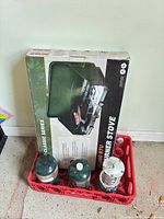 Boxed stove with two propane cylinders and Koehler lantern