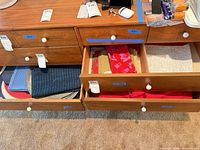 Open drawers showing variety of placemats and linens