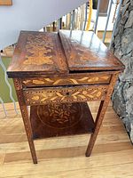Closed marquetry table front view showing drawer and lower shelf