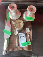 Full lot showing candlesticks, cup, teaspoons and pie server