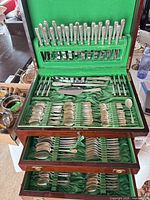 Open chest showing three tiers of flatware