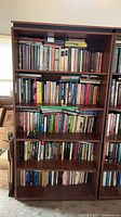 Front view of full bookcase with books showing shelf arrangement