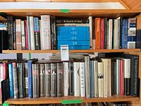 Two shelves filled with assorted hardcover and paperback books