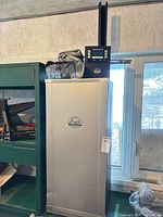 Full view of Bradley electric smoker with control box on top