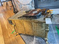 brass wood box with two bellows on top near fireplace