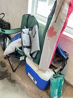 Overview showing Coleman cooler with chairs stacked and nearby