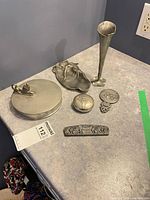 Group shot of six metal items on countertop