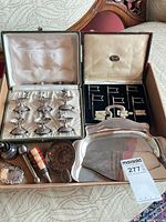 All items grouped in box showing salts in case, food markers case, crumb tray, stoppers, tag