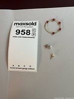 All three single earrings grouped for scale