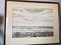 Full view of framed watercolour showing shoreline, waves and sky