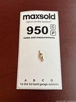 front view of gold pendant on MaxSold card
