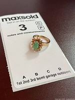 Ring on information card displaying overall design and gold colour