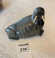 Full view of soapstone walrus sculpture with tusks visible