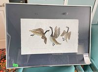 Overall view of framed print showing three geese image and framing