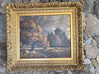 Framed painting on stone wall showing complete artwork and frame