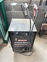 Entire charger with handle, wheels, cables and clamps visible