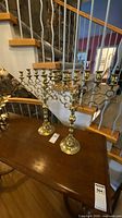 Pair of seven-branch brass candelabras on table