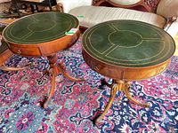Pair of round leather top side tables showing overall design