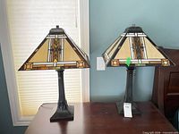 Both lamps on bedside table front view