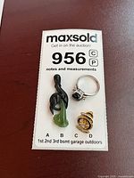 Pendant, ring and pin grouped on ID card