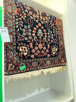 Full view of Persian rug hanging, shows design and size