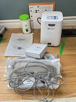 Lot overview with SoClean unit, tubing, wipes, manuals, accessory box