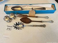 All items grouped: two silver pepper mills, Birks boxed spoon, sterling-handled wooden salad spoon and fork, sterling slotted spoon