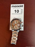 Front view of Tag Heuer Carrera Calibre 16 watch on MaxSold measurement card