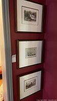 All three framed lithographs mounted on wall