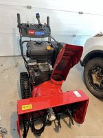 Front view showing auger housing, chute, and control panel