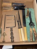 Full lot in box showing all utensils, sword, shears and knives