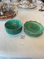 Stack of seven bowls and stack of eight plates showing overall condition and pattern