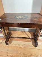 Full view of table front showing top inlay, legs, stretcher